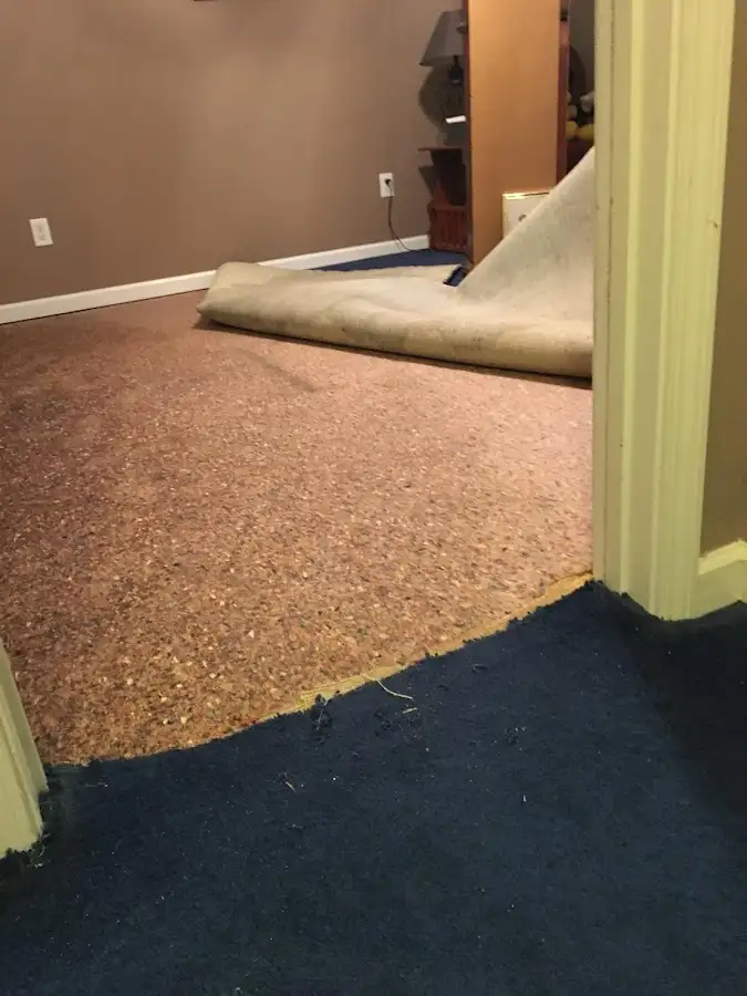 Carpet pad removal revealing water damage during Drying & Dehumidification in Yosemite Lakes